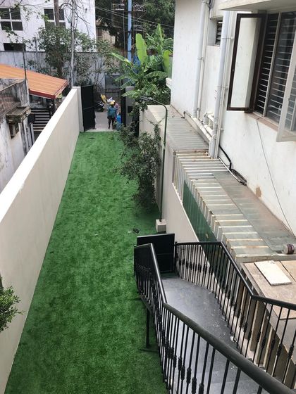 We converted this long, narrow patch of land next to a building into a clean and usable green strip. This is an ideal solution for difficult-to-maintain side yards.