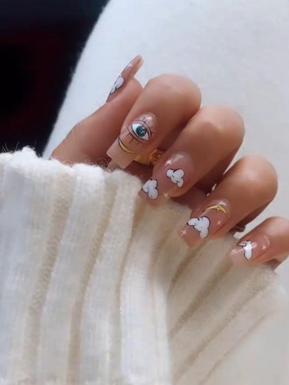 Pretty nails only. This whimsical design features a sheer base with hand-painted clouds, stars, and an evil eye for a unique and trendy look.
