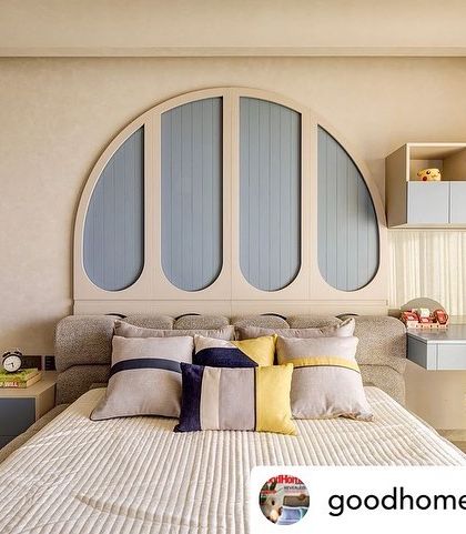 This bedroom from a Good Homes Magazine feature shows a custom arched headboard and a built-in desk. The design prioritizes function while maintaining a soft, nature-inspired aesthetic.