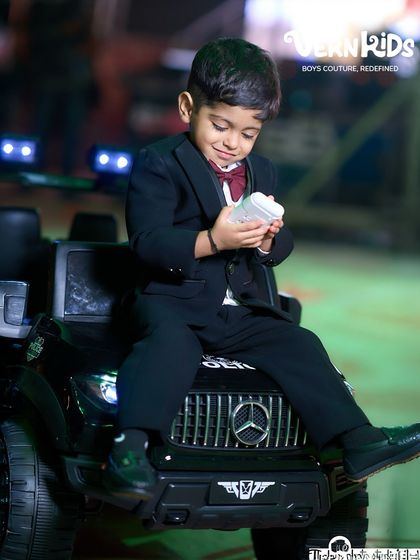 Taking a moment to enjoy the party. A custom-fit tuxedo ensures he looks sharp from every angle, making for unforgettable birthday photos.