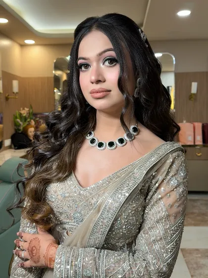 A close-up of this party glam look. We did a sharp, winged eyeliner and a contoured base, paired with a modern nude lip, perfect for an evening event.