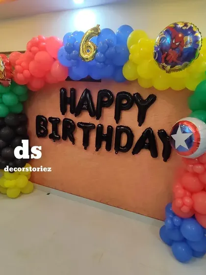 An action-packed Avengers theme for a 6th birthday. This setup features a colorful balloon arch with character foils of Captain America, Iron Man, and Spider-Man against a neutral backdrop.