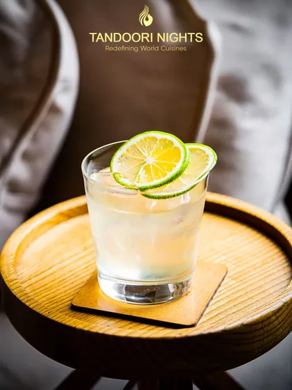 Raise a glass to summer vibes. Sip on sunshine with our seasonal delights, like this classic gin and tonic with a fresh lime garnish.