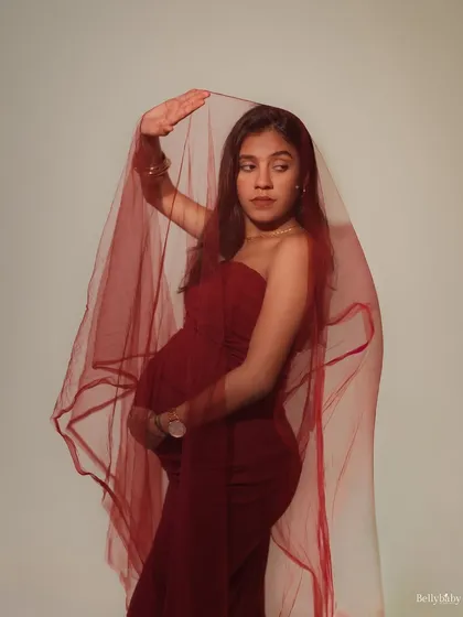 There is such power and grace in this journey. This portrait, with the deep red veil, is about celebrating the mother's strength and the timeless, artistic beauty of pregnancy.