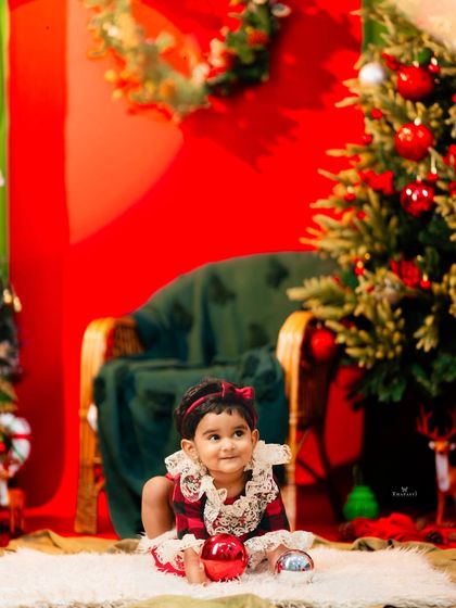 A sweet moment of curiosity as this toddler explores the Christmas decorations.