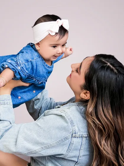The playful, dynamic moments are just as important as the posed ones. Here, I captured the pure joy and energy between a mother and her baby girl, freezing a moment of laughter and love in a clean, studio setting.