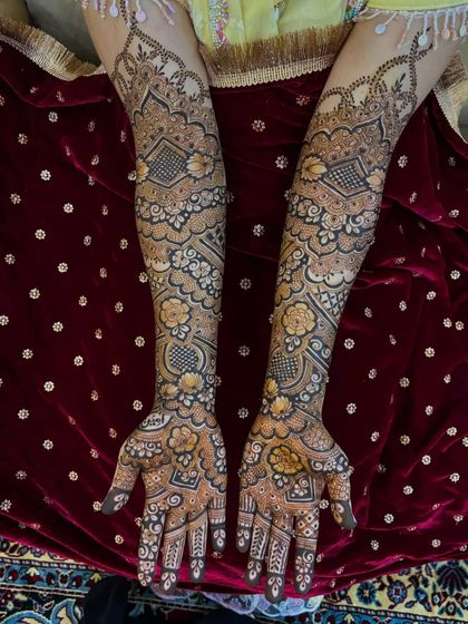 Another shot of Mariam's mehendi against a rich red velvet background.
