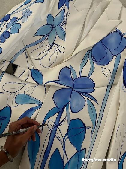 A blue coral palette is perfect for a carnival theme. Here, I'm outlining bold, abstract blue flowers on a white jacket, creating a fresh and vibrant look.
