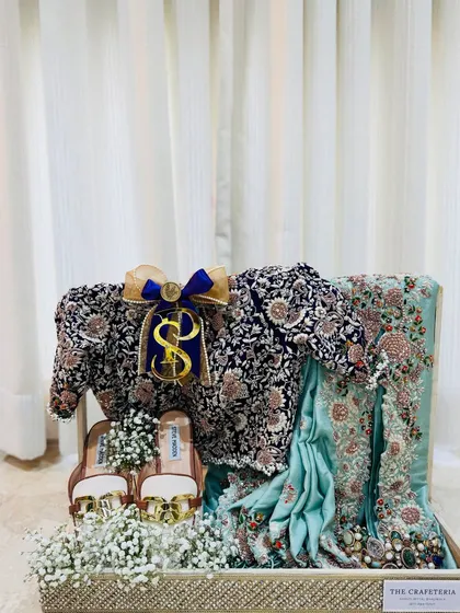 A stunning navy and mint green saree, paired with sparkling Steve Madden heels and surrounded by a bed of baby's breath for a dreamy presentation.