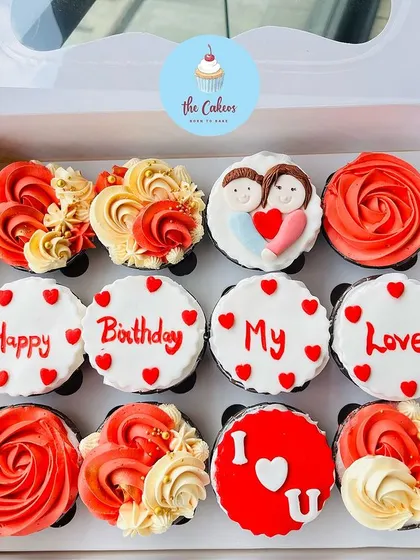 A box of my custom eggless cupcakes is the perfect way to send a personal message. This set was designed for a birthday, featuring hand-piped roses, a cute couple illustration, and the message "Happy Birthday My Love" spelled out across the treats.