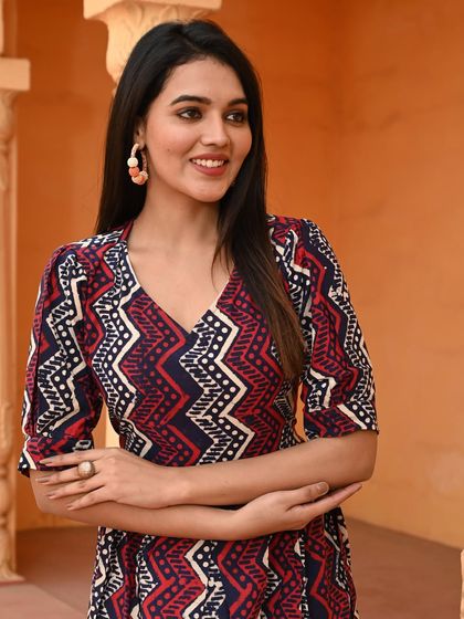 A close-up of the geometric chevron print dress, highlighting the vibrant colors and sharp details of the block print.