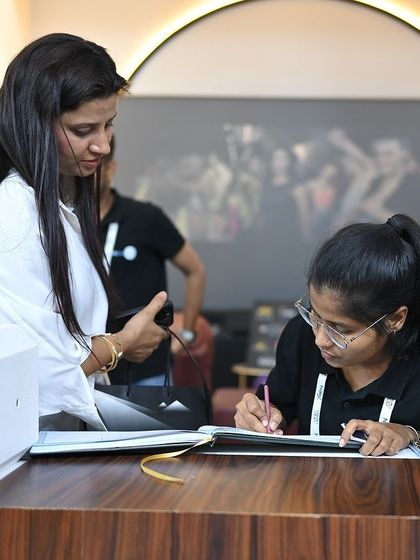 Every inquiry is important. Here, a member of our team assists a visitor at our front desk, ensuring everyone who stops by gets the information and attention they deserve.