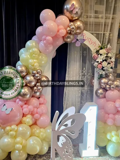 A close-up of the butterfly balloon arch, showing the delicate color transitions and butterfly details.