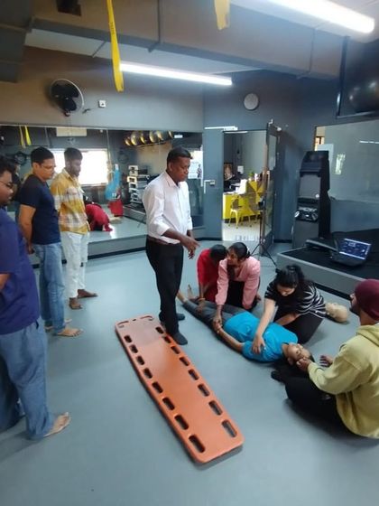 Students learn how to safely move an injured person onto a stretcher. Our first aid training covers various emergency scenarios.