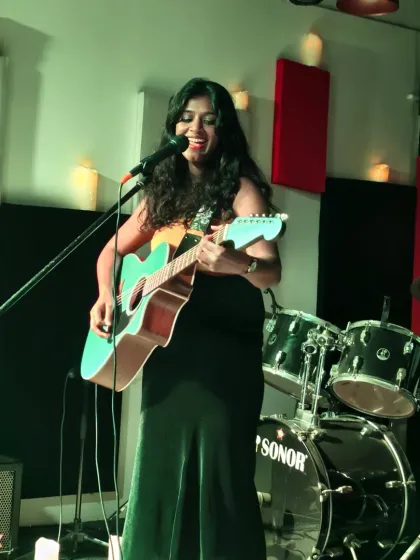 A powerful shot of a singer-songwriter lost in her music. This is what it's all about: providing a professional setup with great sound and lighting, so you can focus on delivering a killer performance.