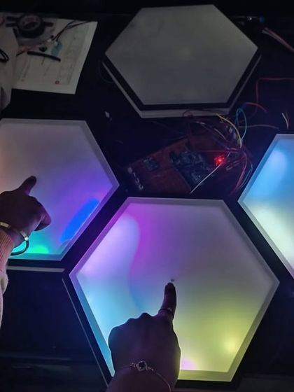 This is the 'Canvas Beats' team with their Breakthrough Award-winning project at the FIRST LEGO LEAGUE (FLL) challenge. They created these incredible touch-sensitive hexagonal light pads, showing amazing progress in both their technical skills and confidence.