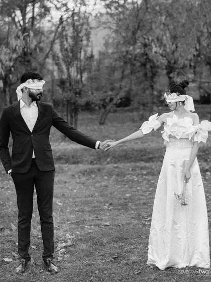 A conceptual pre-wedding photo in Kashmir. Blindfolded, they hold hands, a symbol of their complete trust and the journey they are taking together into the unknown.