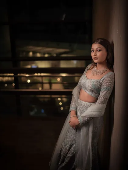 A moody and atmospheric shot of a Sangeet bride. Her makeup features a soft, ethereal glow with a hint of shimmer on the eyes, creating a dreamy and romantic look.
