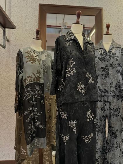 A collection of luxurious silk co-ord sets by Peachoo in shades of grey and black, featuring delicate prints and embroidery.