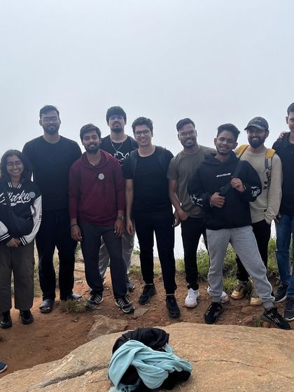 A group of friends who met on our trek, posing for a photo at the summit.
