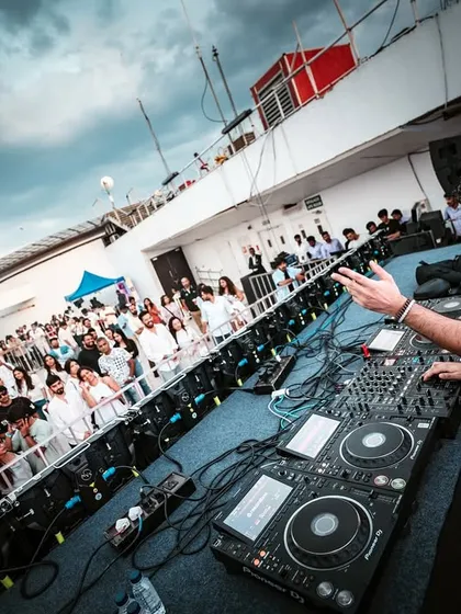 Our signature 'White Party' is an iconic open-air affair. Here, DJ Vizdumb commands the deck at High Ultra Lounge, demonstrating how we transform rooftop venues into stylish, high-energy day parties with a unique thematic dress code.