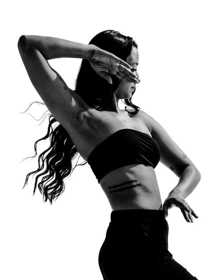 A powerful black and white image from 'A Movement Series', where the hand partially obscures the face, creating a sense of mystery and introspection.