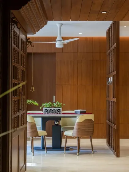 The dining area is framed by traditional wooden doors, creating a formal and elegant space for meals.