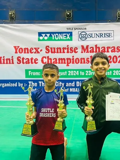 Adhiraj and his partner posing on the court with their championship trophies. A fantastic achievement for these young players.