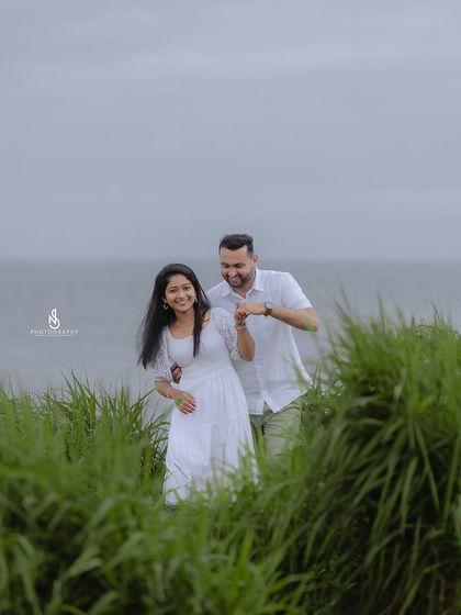 Walking through tall green grass with the ocean behind. This composition creates a beautiful sense of depth and adventure.