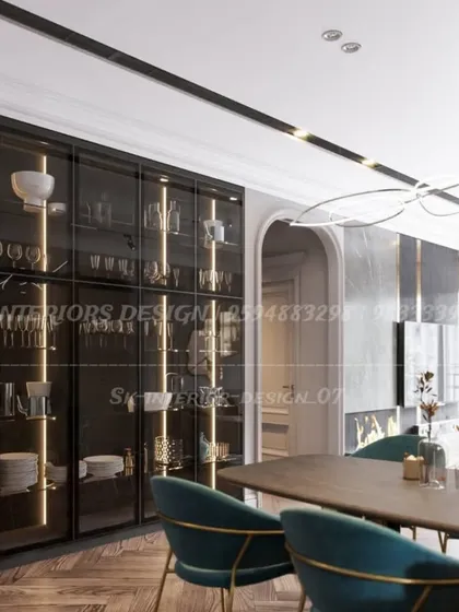 For clients with extensive collections, I design floor-to-ceiling crockery units like this one. The dark frame, clear glass, and vertical strip lighting turn everyday items into a beautiful display.