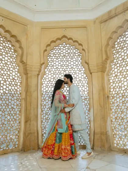 Inside the historic walls of Amber Fort, I use the intricate jali windows to frame your connection. It’s about finding those quiet, intimate moments amidst the royal splendor, creating a timeless portrait of your love.
