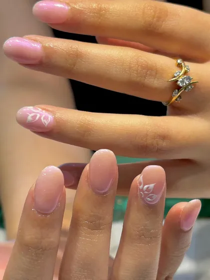 Another view of the elegant and simple petal-adorned nails, perfect for a minimalist yet beautiful look.
