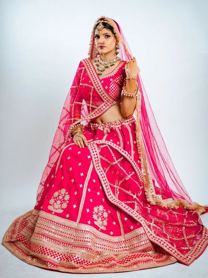 This full seated portrait shows the grandeur of the Marwari lehenga, perfect for your wedding album photos.