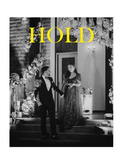 A black and white shot of the groom leading the bride down the stairs, with the word "HOLD" in bold yellow, adding a graphic design element.