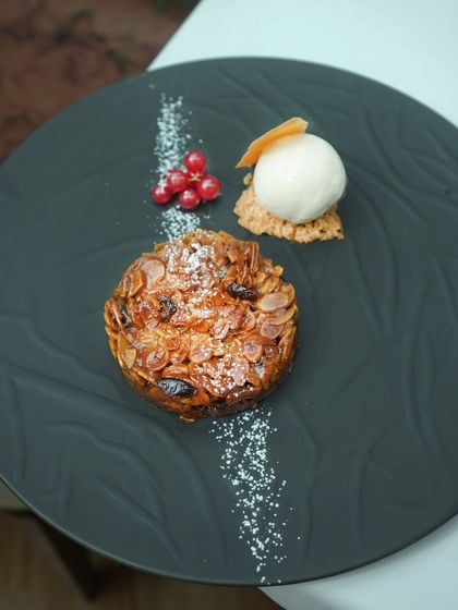 Flakes of almond and caramelized fruit are bound in a silken halwa, resting on a crumbly base. Paired with house-made ice cream, this dessert feels like winter weddings, plated just for you.