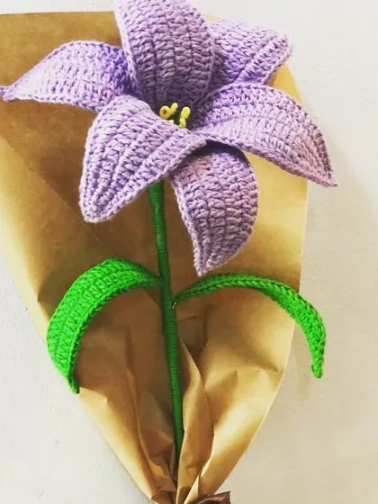 I love working with different colors, and this purple lily is a great example. The rich color and detailed stitching make it a striking piece that stands out in any bouquet or as a single stem.