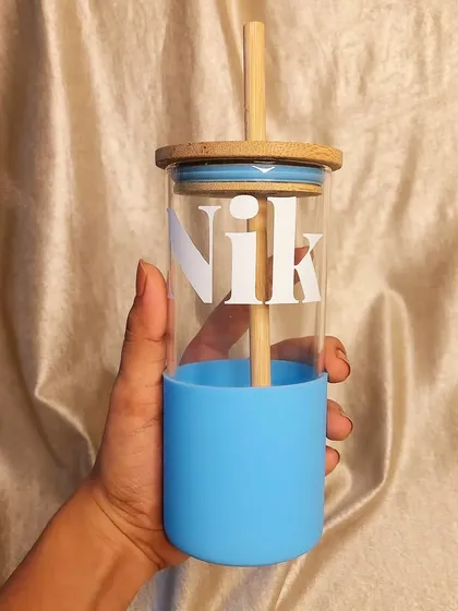 Stay hydrated with your perfect sipper companion. This glass tumbler with a bamboo lid and straw comes with a silicone sleeve and can be personalized with a bold initial design.