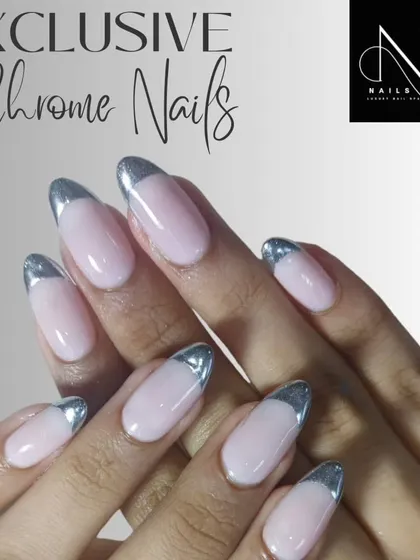 An elegant chrome French manicure. We used a highly reflective silver chrome for the tips on these almond-shaped nails, offering a modern alternative to the classic white.