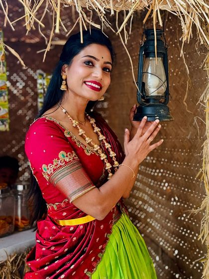 A close-up shot that highlights the beautiful embroidery on the blouse and the traditional jewellery.