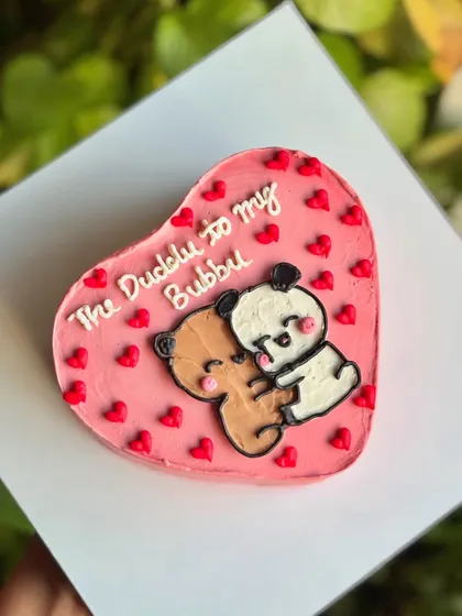 A top-down view of the Duddu Bubbu cake, showing the adorable illustration and the sweet message, perfect for an anniversary or just because.