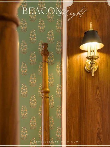 A close-up of a classic wall sconce next to a wooden bedpost, showcasing elegant lighting choices.