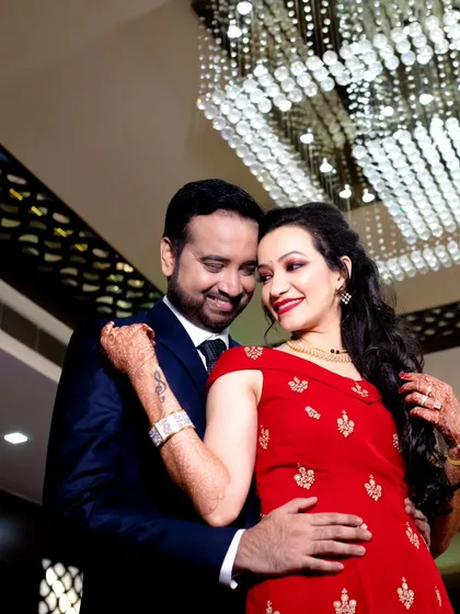 A beautiful, happy moment between the newlyweds at their reception. Their smiles and the grand setting create a perfect memory of their celebration.
