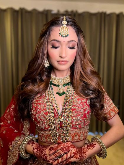 A close-up on the details. This shot highlights the soft, smokey eye makeup and the intricate henna design, all part of the complete bridal story.