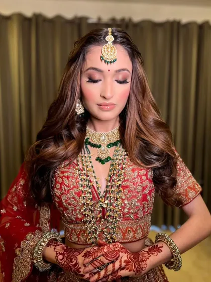 A close-up on the details. This shot highlights the soft, smokey eye makeup and the intricate henna design, all part of the complete bridal story.