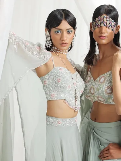 Part of the Seema Thukral 'Rumi' campaign, this group shot features models in delicate mint-green ensembles. The styling incorporates unique jewelry pieces, like a facial accessory, to add a layer of artistry to the soft, romantic collection.