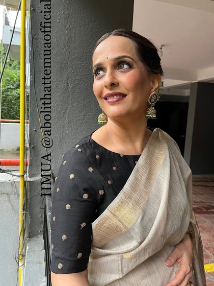 A close-up of Rashmi's makeup. The look is simple yet sophisticated, with defined eyes and a warm lip color.