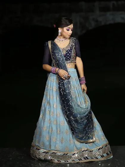 A serene and elegant light blue lehenga with gold work. This is a perfect choice for a daytime engagement or a summer wedding.