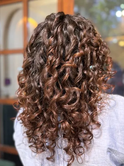 Nothing like a warm Mocha to enrich dark curls. This subtle no-bleach balayage adds a soft, coffee-toned dimension that catches the light beautifully.