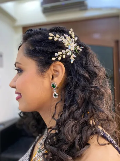 We provided makeup and natural hair styling for this beauty's special event. The delicate hair accessory perfectly complements her defined curls.