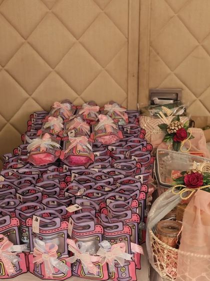 A closer look at the stacks of adorable baby shower return favors, all ready for the guests. Each mini bag is packed with care to thank guests for celebrating the parents to be.